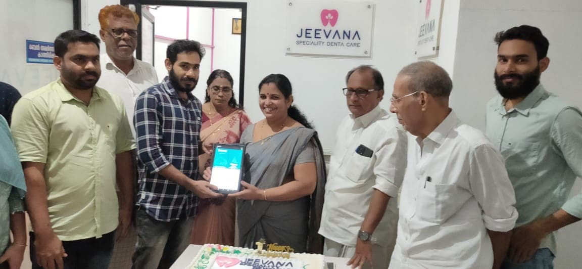 Kozhikode District Panchayath President Sheeja Shashi launching the profile on tablet at Jeevana Dental Care